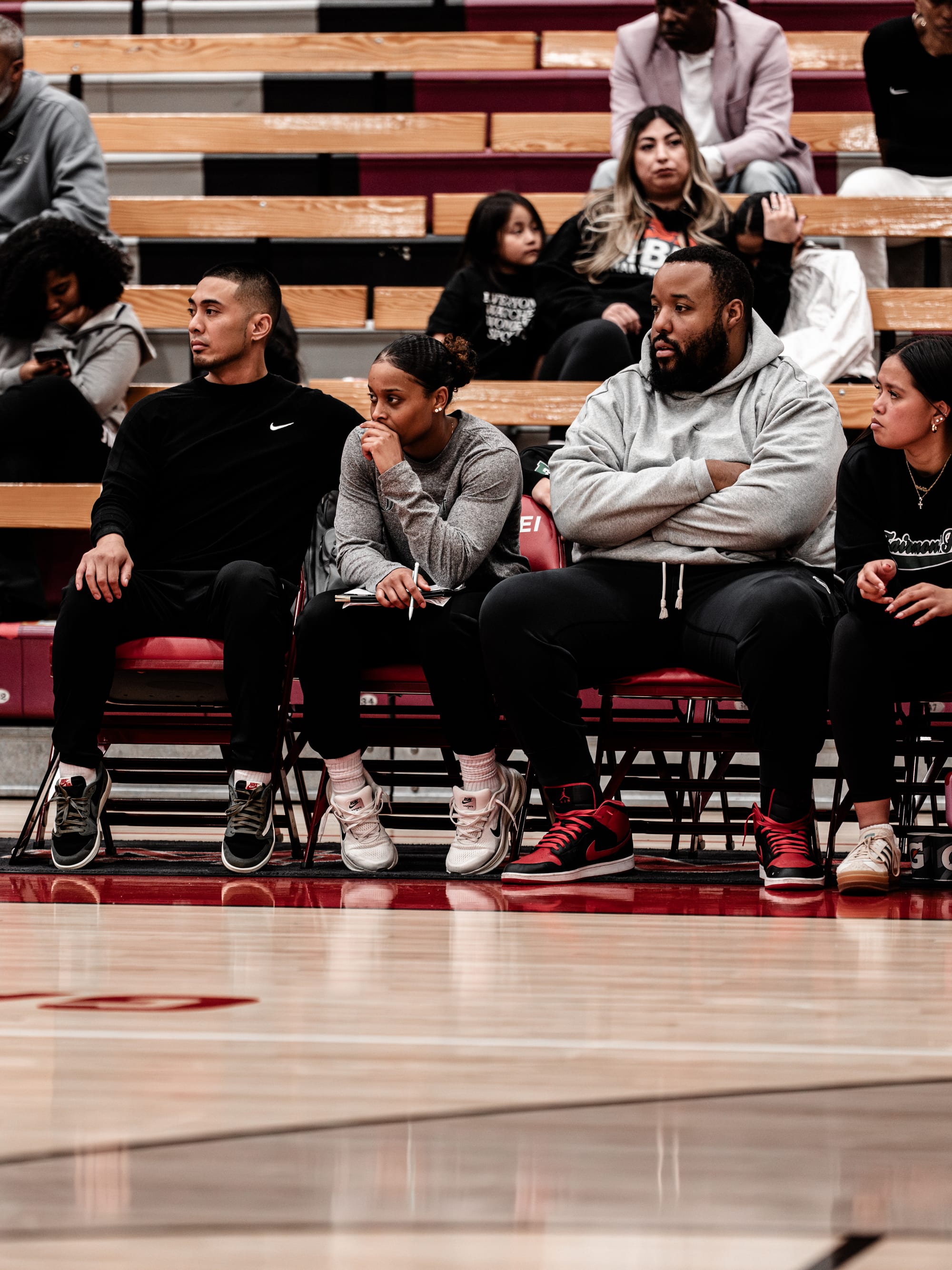 The WE-R1 coaching staff watching a game from the bleachers