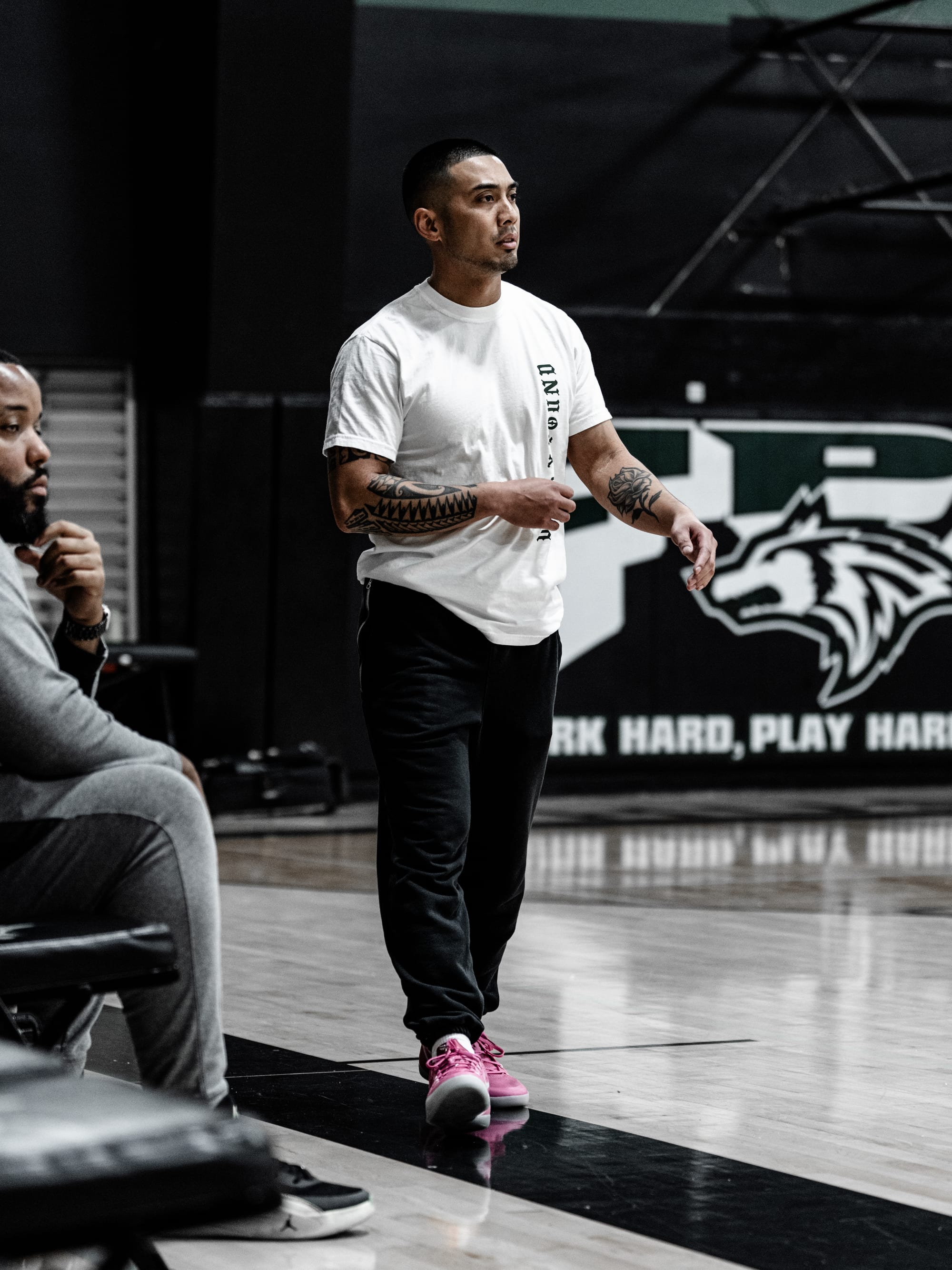 Coach Josh Lozano on the floor at practice