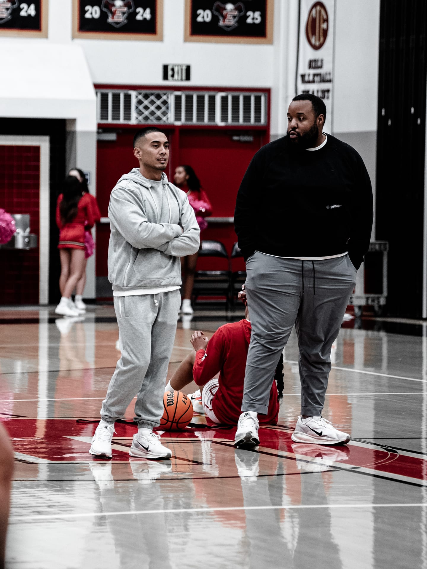 Coach Josh and Coach Vic standing courtside