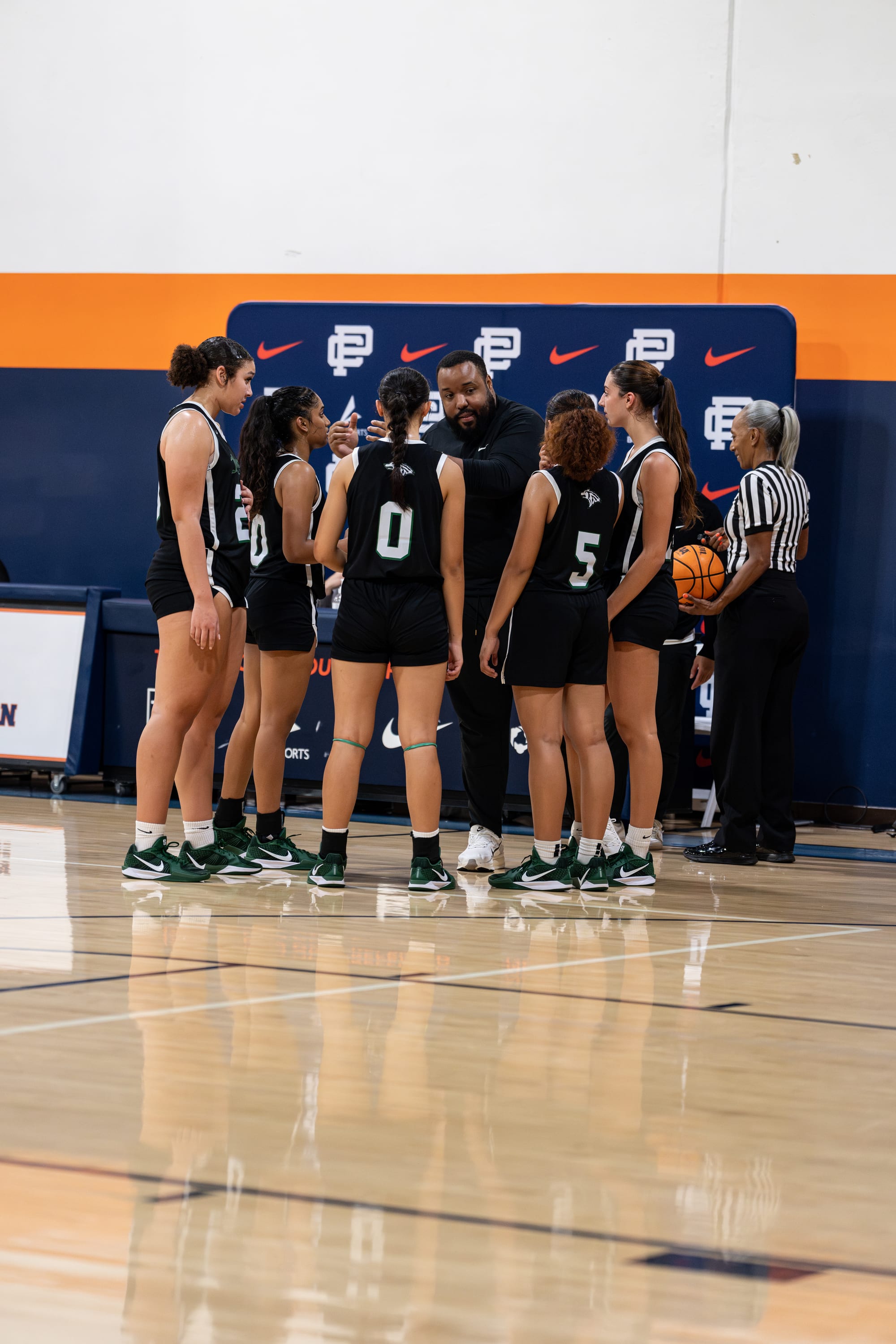 WE-R1 team huddle on the floor