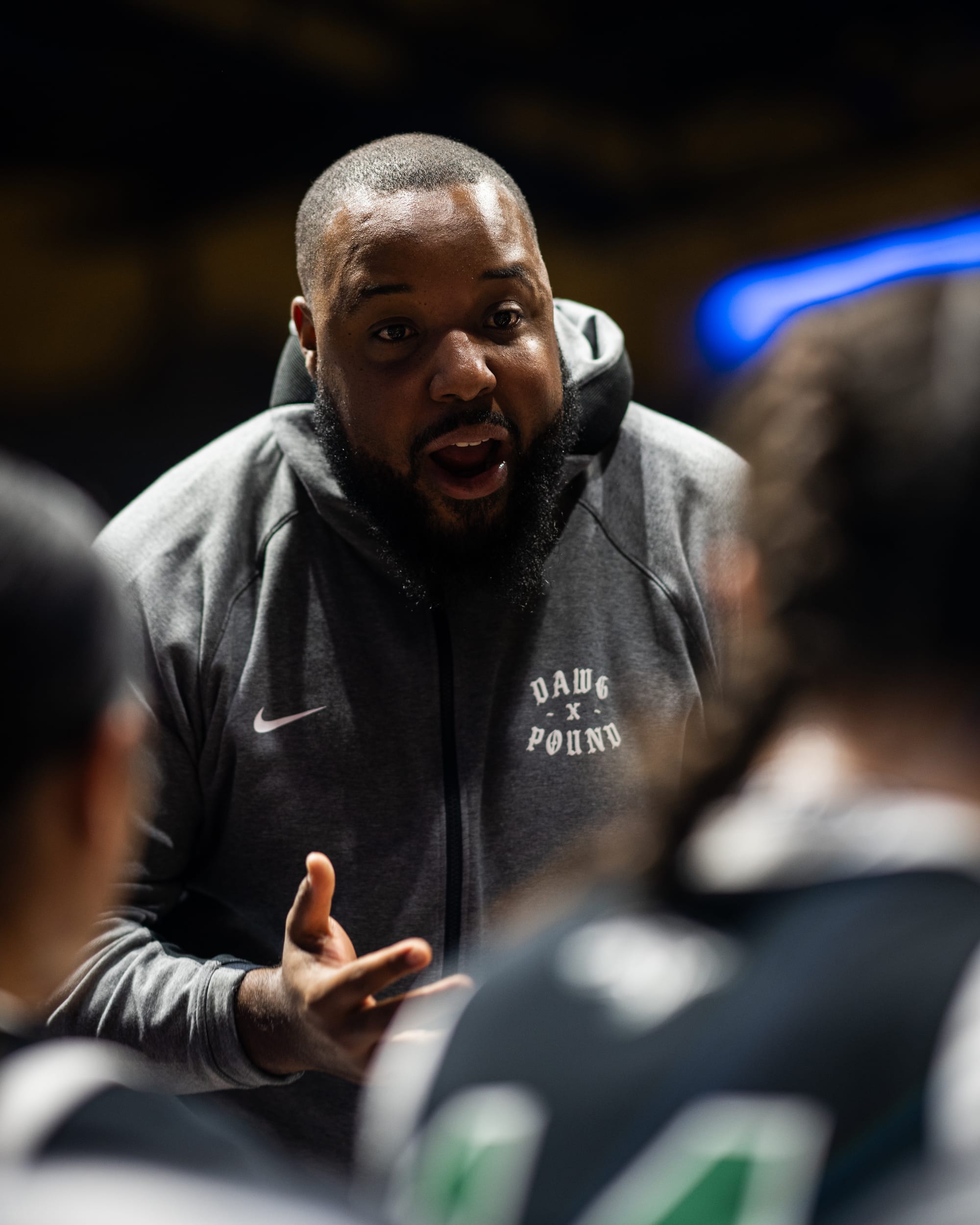 Coach Vic Martin coaching, in a Dawg Pound hoodie